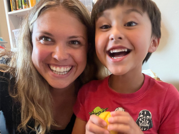 Adult and child smiling.