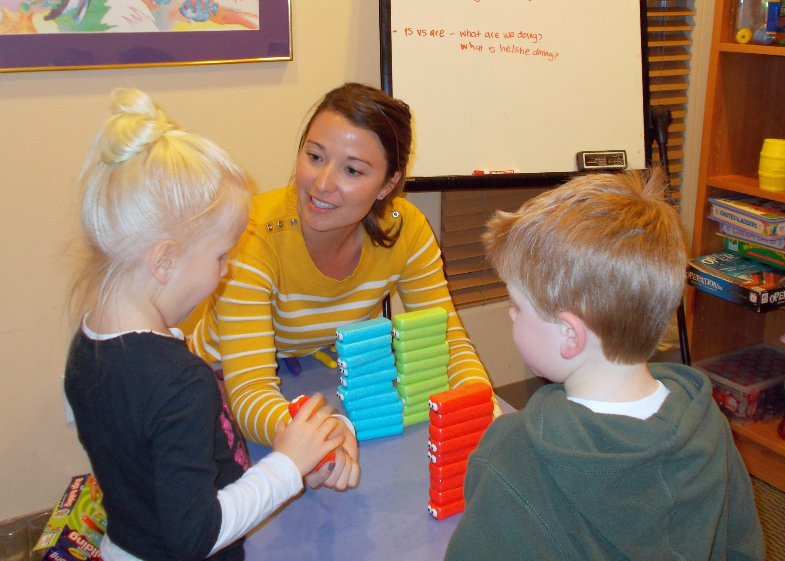 Kids playing with blocks with a staff member